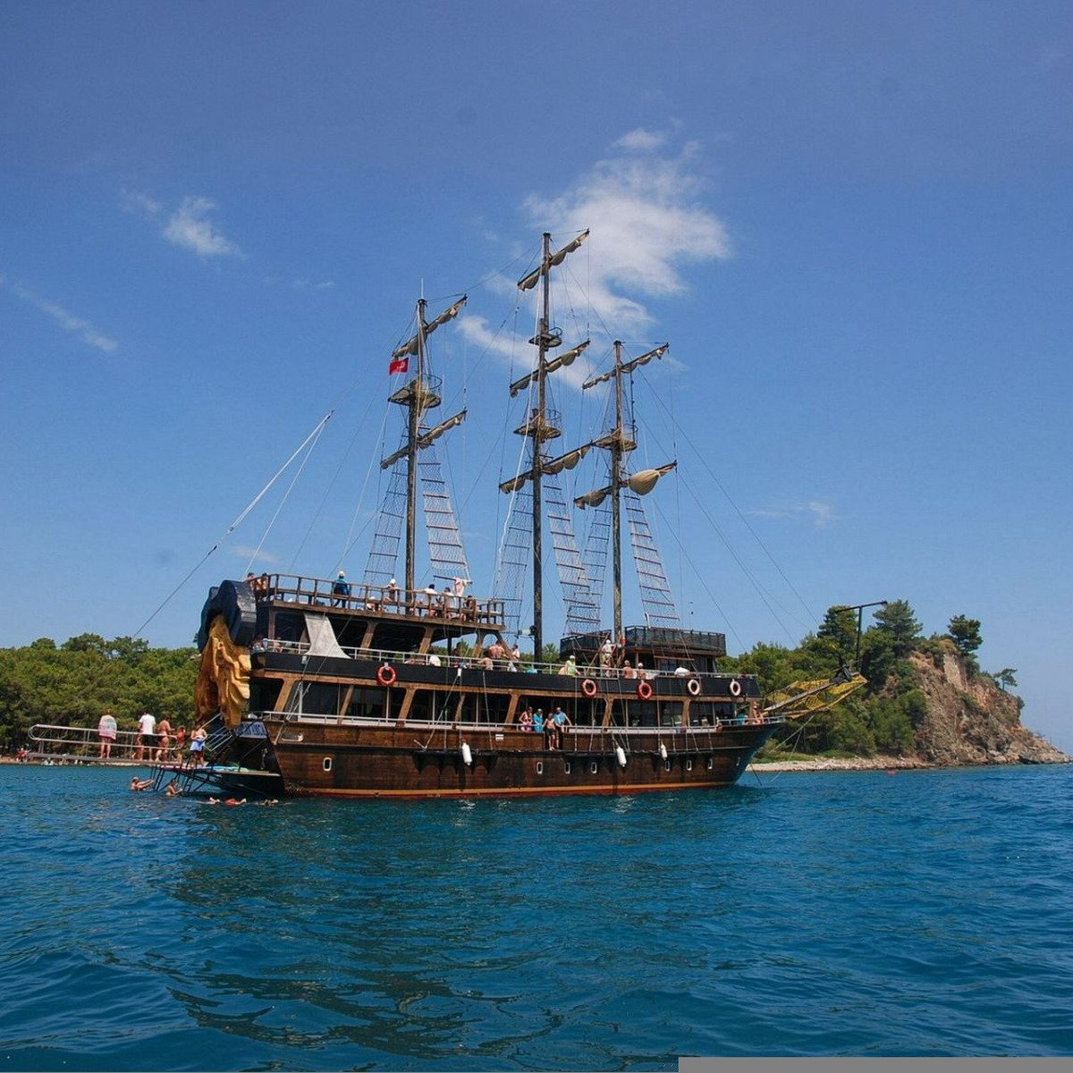 Pirate boat anchored near forested bay