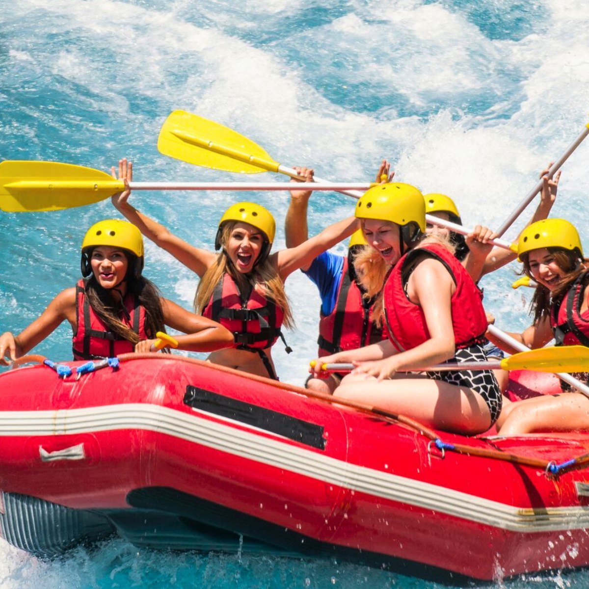 Rafting crew celebrating in rapids