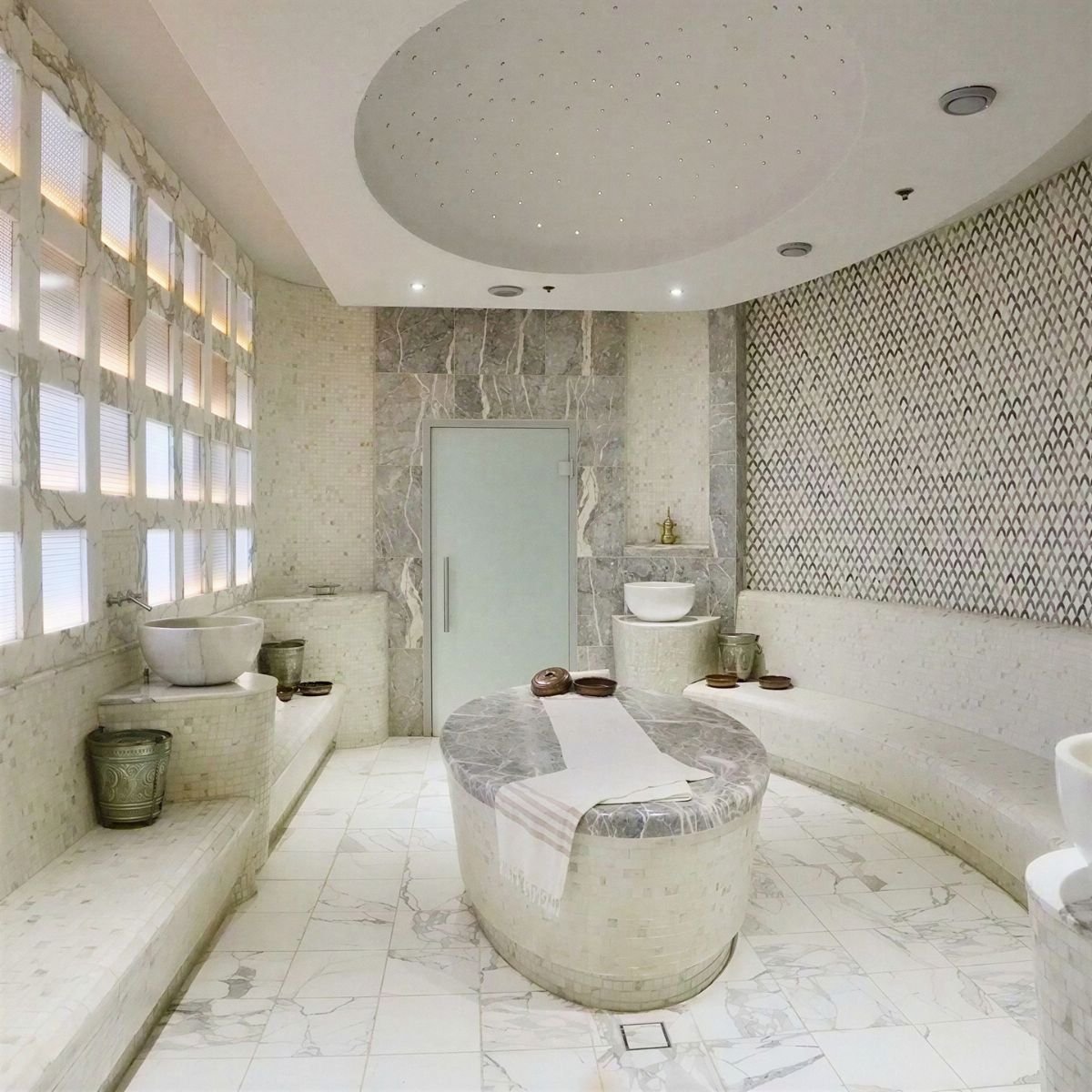 Elegant marble hamam interior with domed ceiling and Iznik tile panels