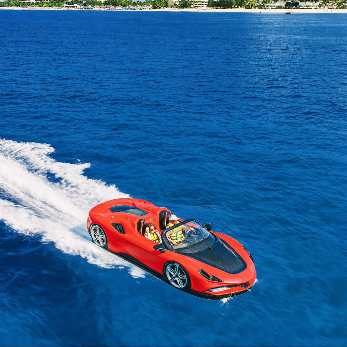 Red jet car speeding across turquoise water