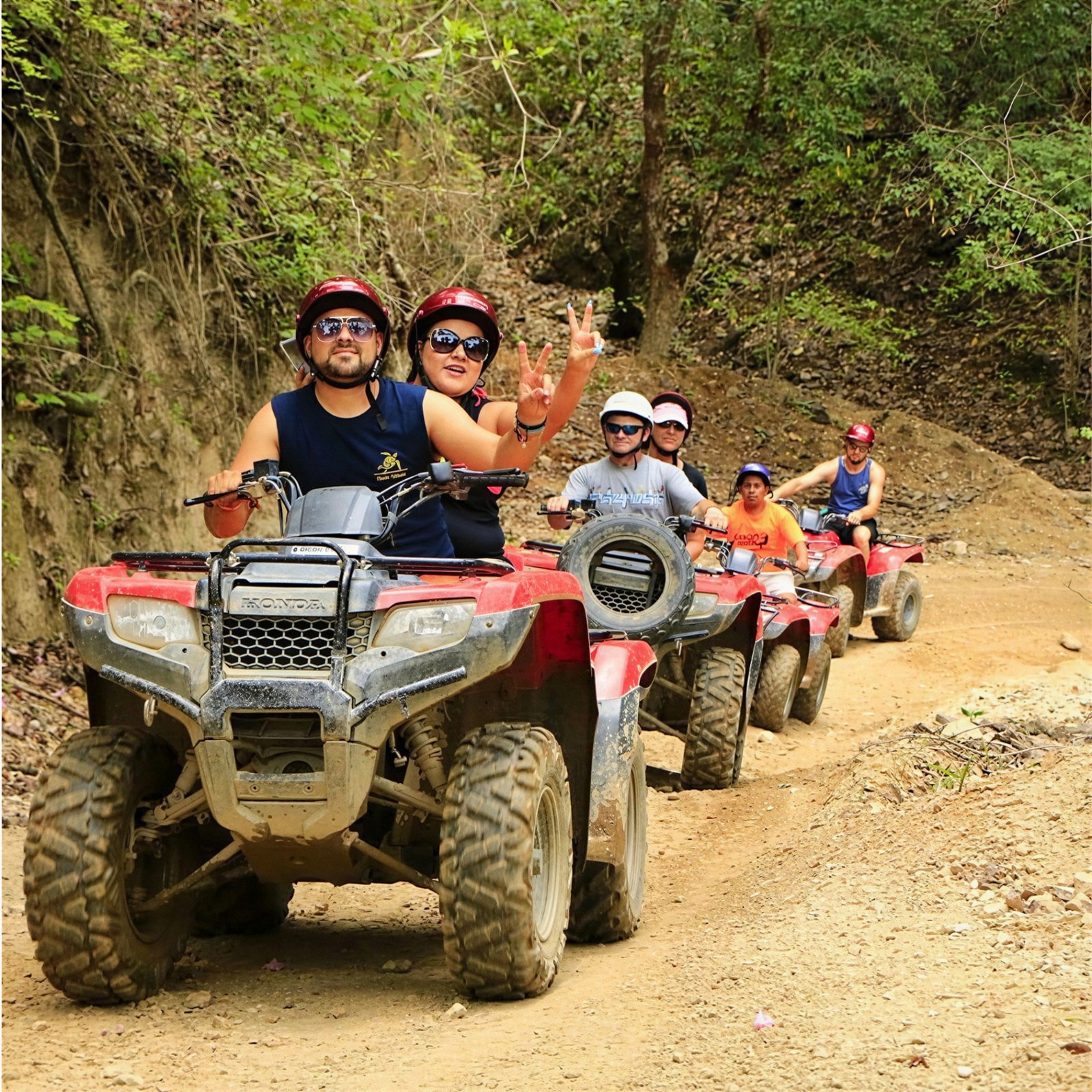 Quad Safari group riding through forest trail
