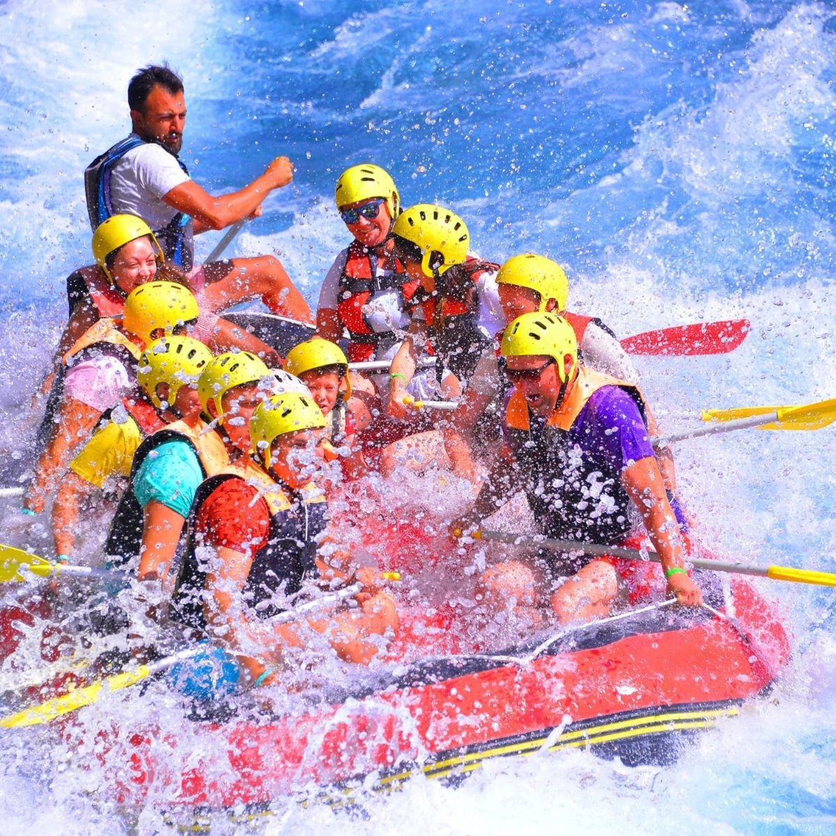 Excited rafter paddling through the canyon