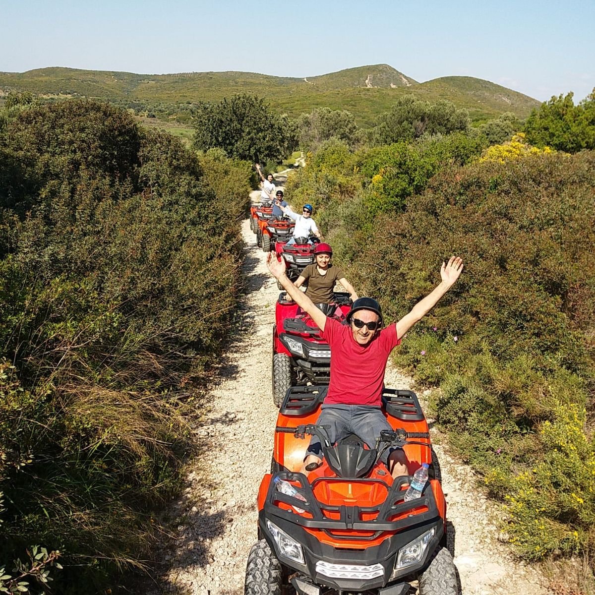 Group of quads riding through countryside trail