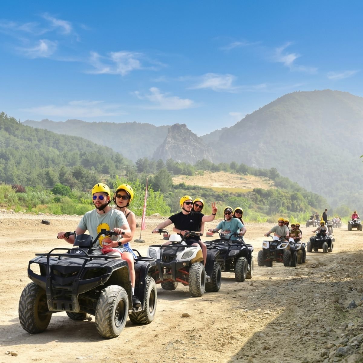 Line of quad riders on mountain dirt road