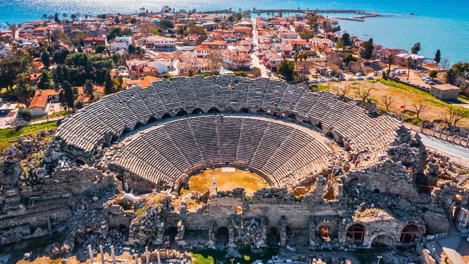Aerial view of the ancient theatre of Side with old town and sea — Turkish Riviera