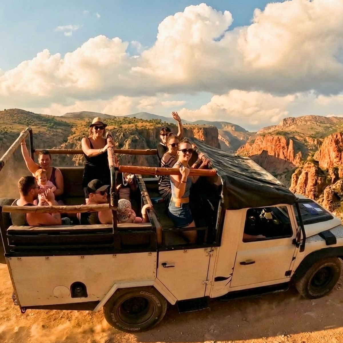 Jeep with guests on a mountain viewpoint at sunset